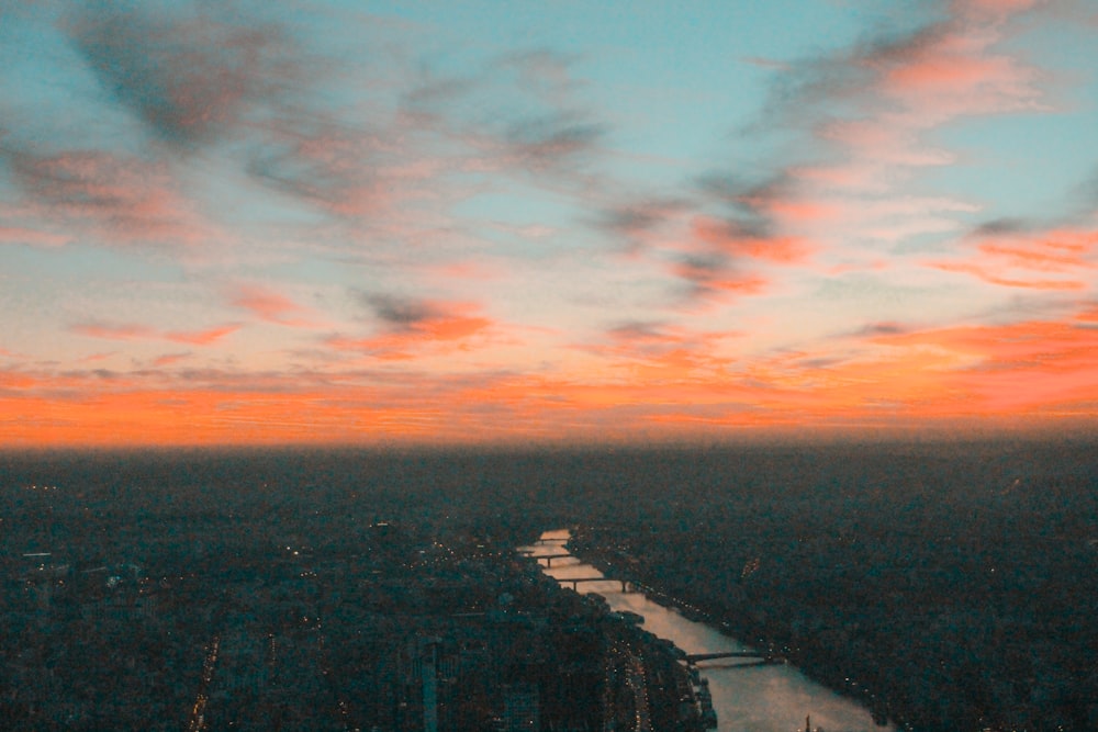 a view of a river and a city at sunset