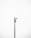 A minimalistic image featuring a single security camera mounted on a tall metal pole against a plain white background. The setup is centralized and the black and white color scheme adds a stark contrast, emphasizing the industrial design of the camera.