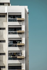 A high-rise apartment building with balconies overlooking the city.