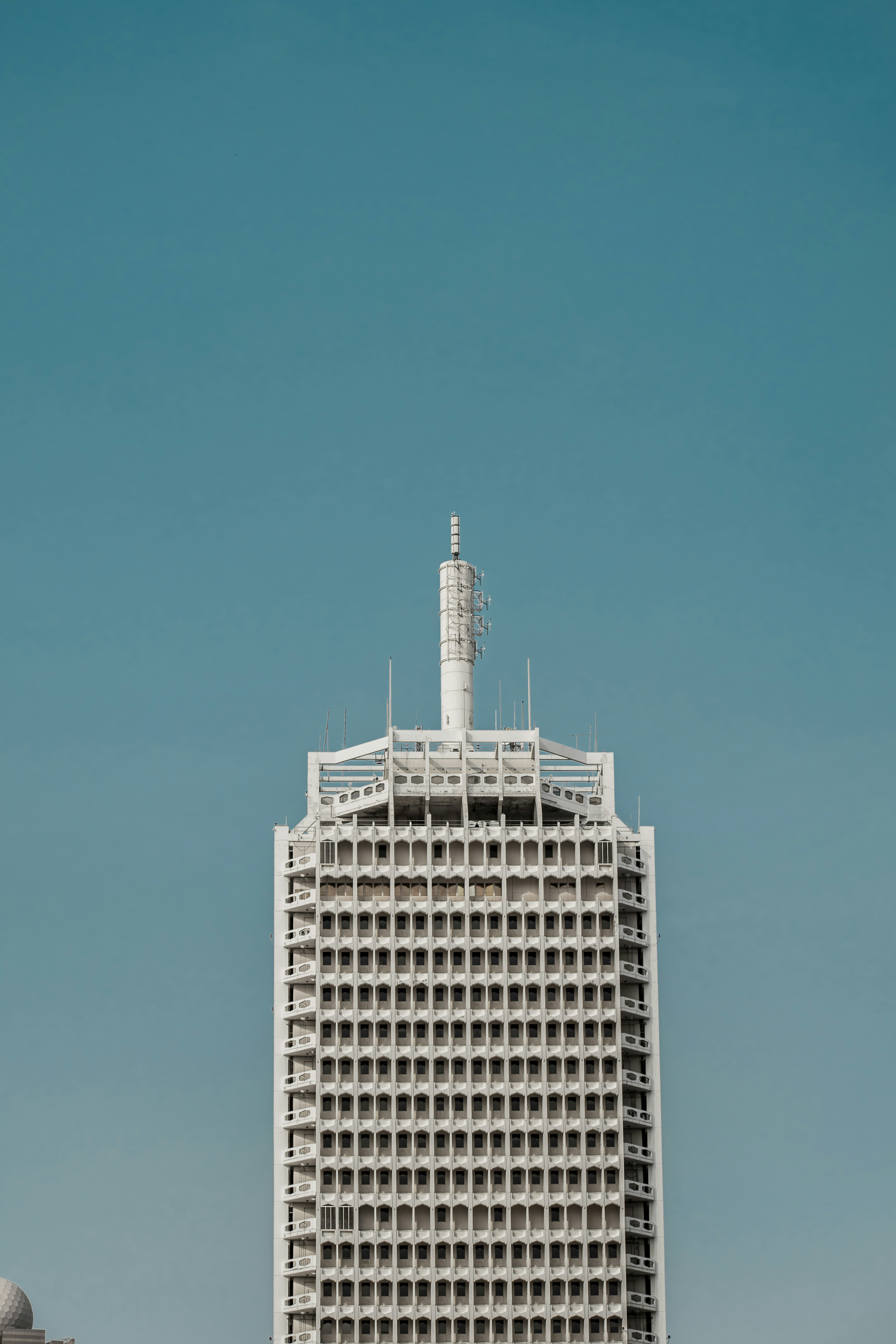 a tall white building with a sky background