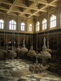 A spacious hall featuring gleaming marble surfaces and natural light.
