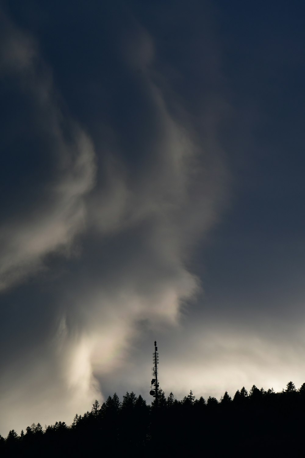 a very dark sky with some clouds in the background