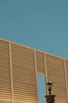 Architect reviewing facade design blueprints with a client outdoors.