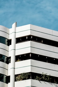 Finished building exterior featuring crisp white walls with green and grey accents.