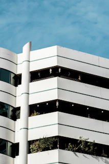 Completed exterior painting of a multi-story building with crisp white and gray tones