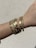A wrist adorned with a chunky gold bracelet from Golden Link Jewellery.