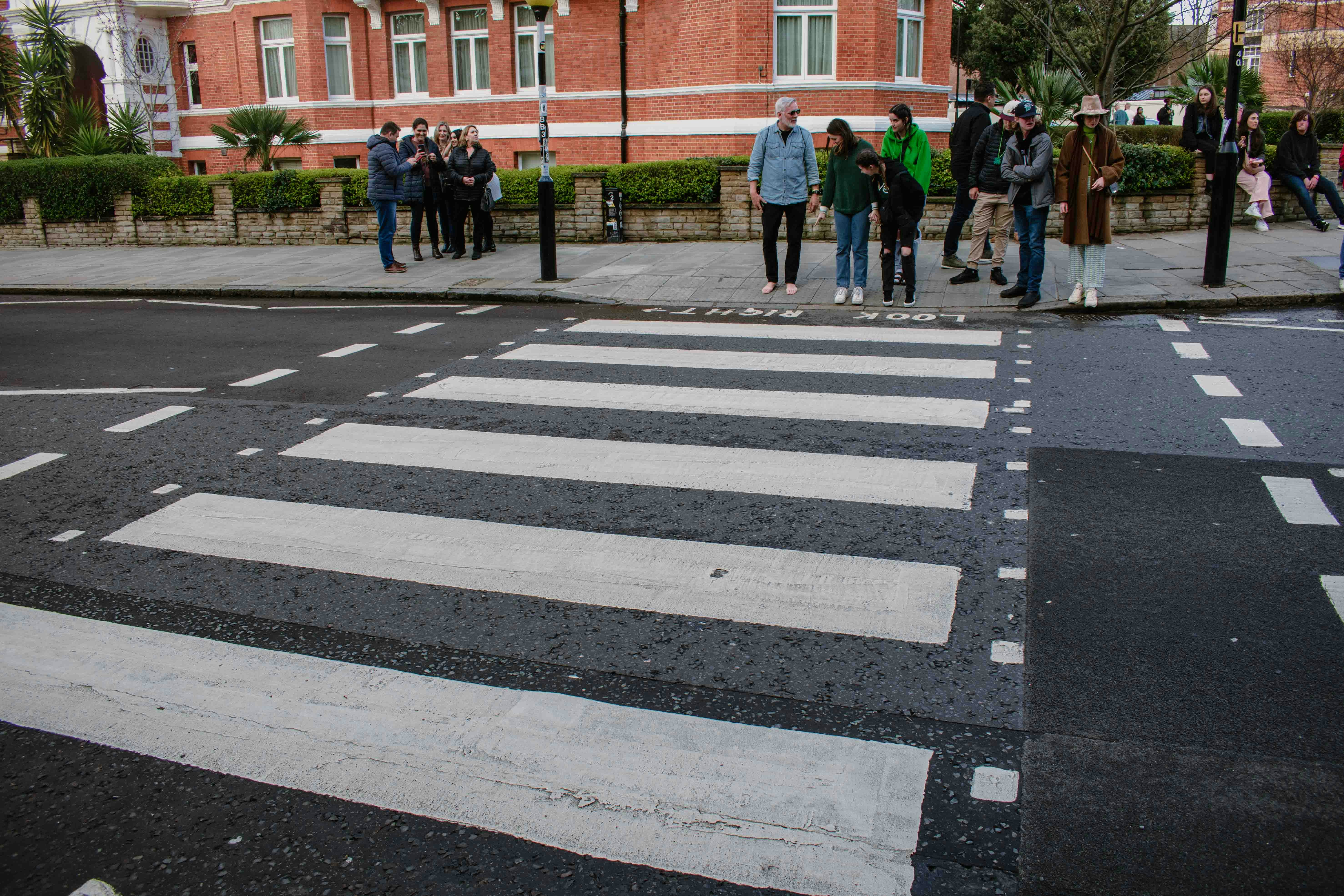 a group of people standing on the side of a road