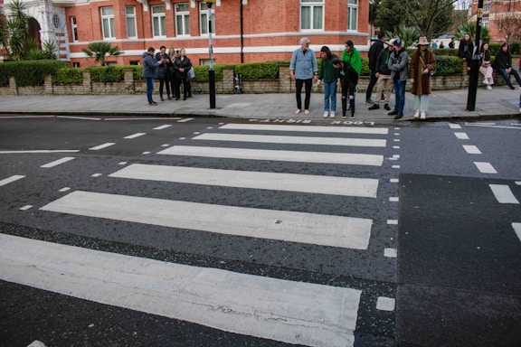 a group of people standing on the side of a road