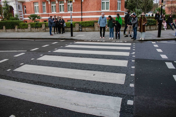 A classic black-and-white photo of The Beatles walking across Abbey Road.