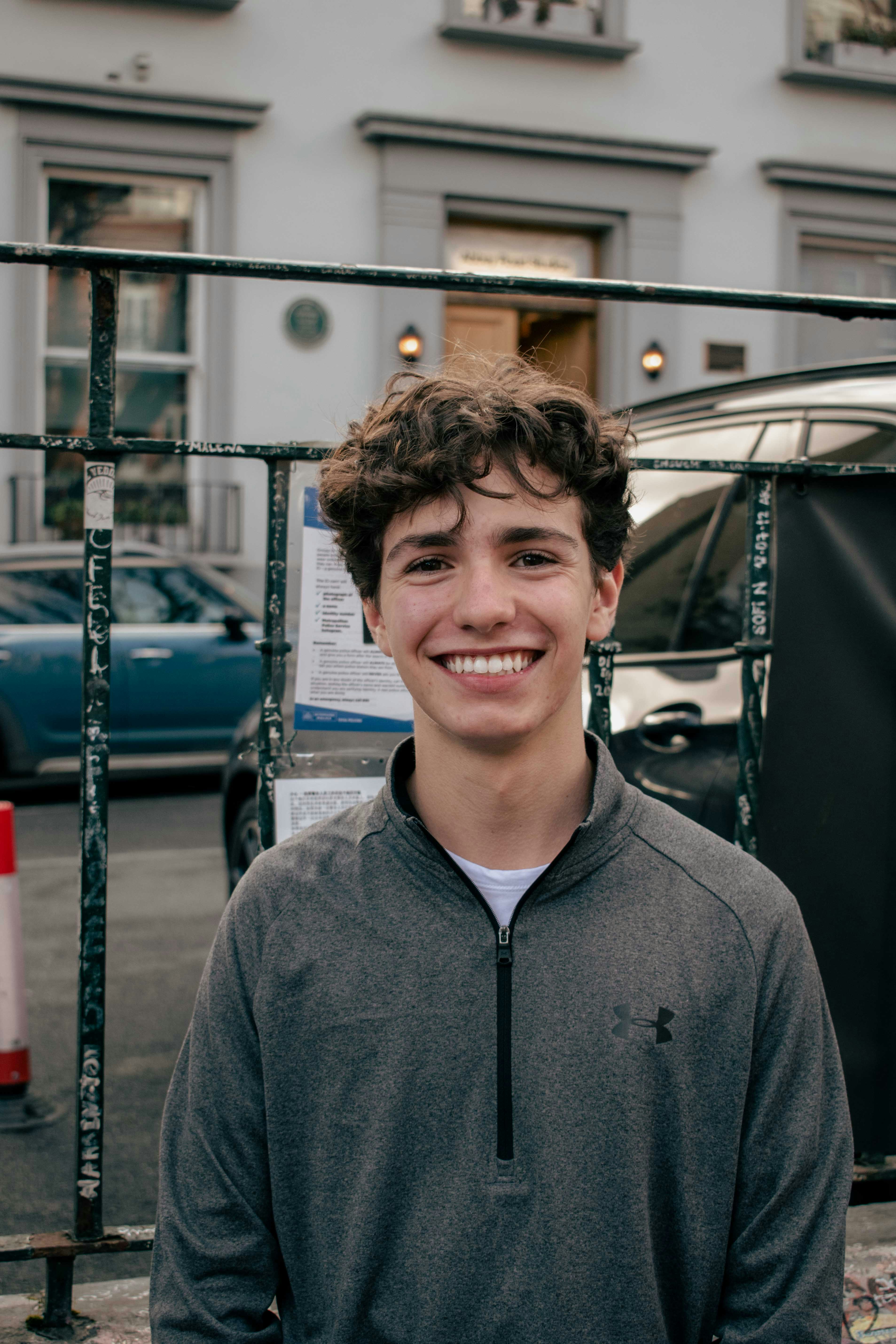 Young man in casual streetwear smiling