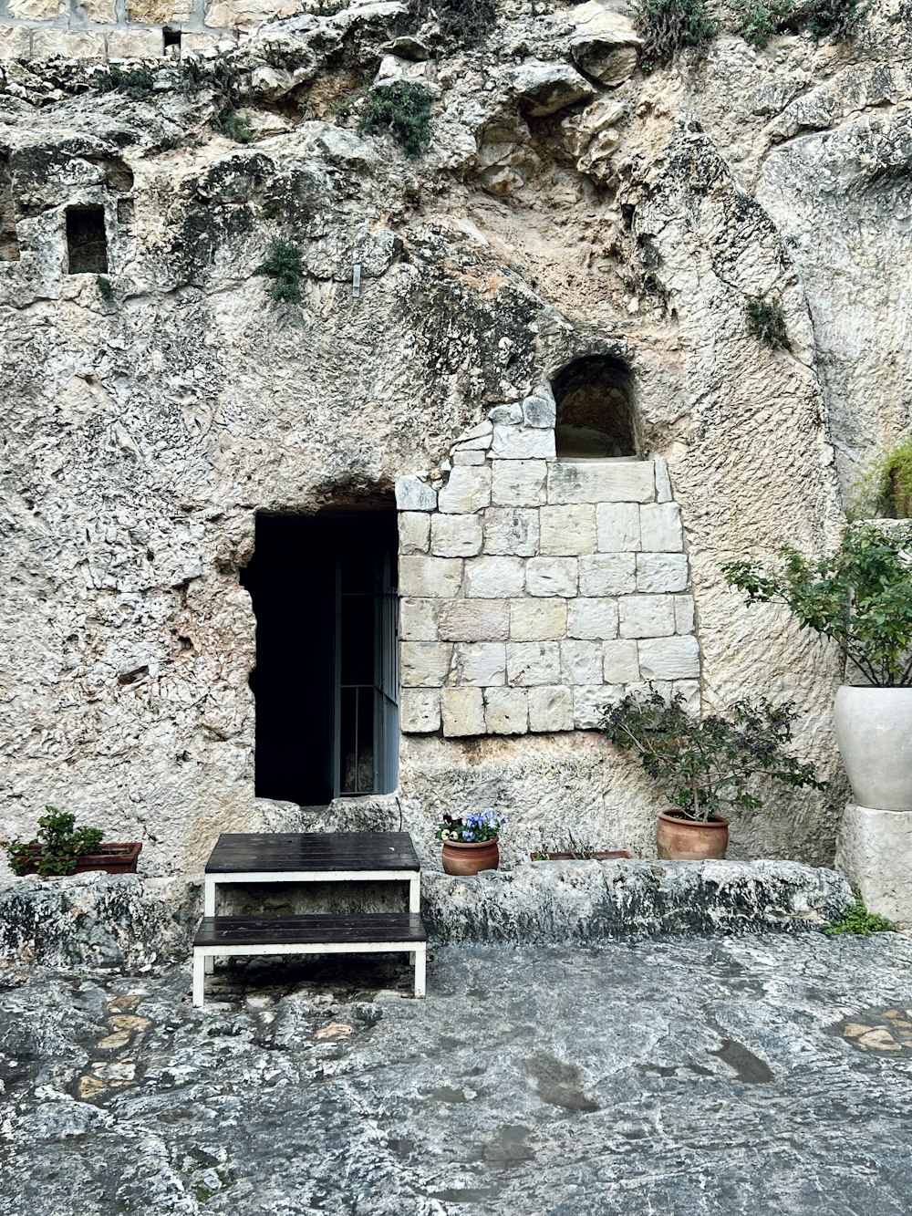 a stone building with a door and steps leading up to it