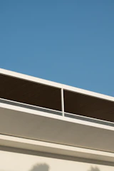 Modern blue roof with sleek, clean lines on a sunny day.