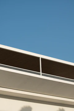 Modern blue roof with sleek, clean lines on a sunny day.