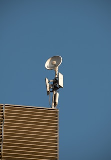 Professional team installing a satellite antenna on a residential building