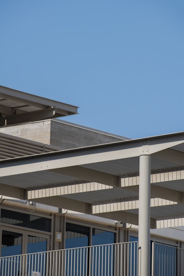 Modern architectural blueprint alongside a sleek urban building exterior.