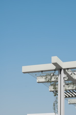 Photo of a modern pergola with integrated photovoltaic panels in a residential garden.