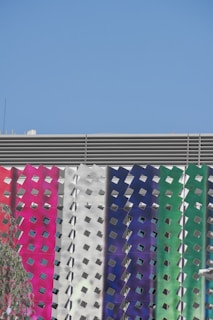 Decorative panels installed on a modern office facade under clear skies.