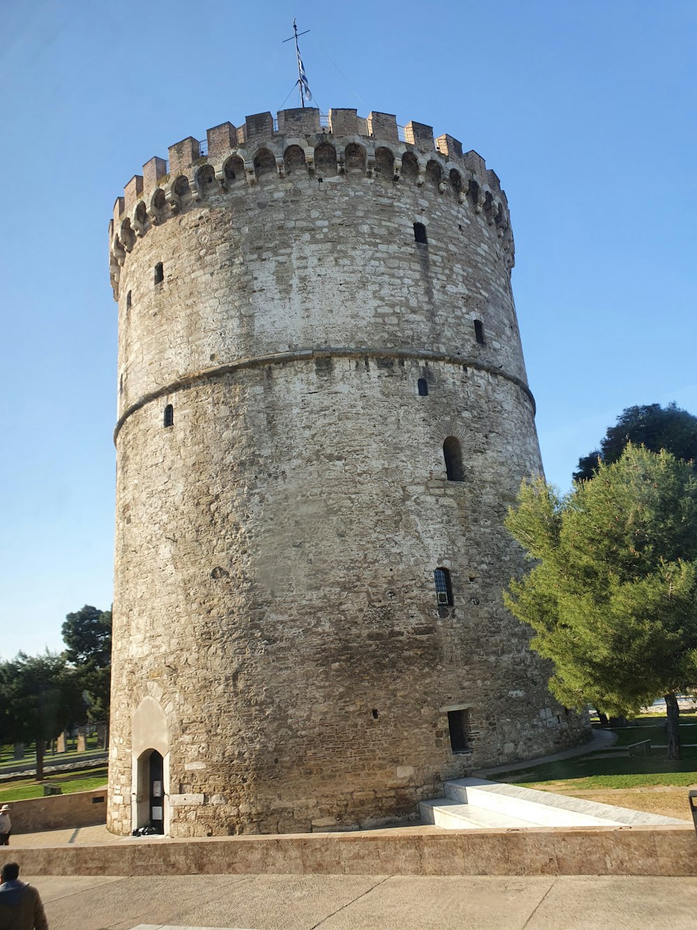 a large stone tower sitting next to a park