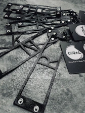 Military-style dog tags with crisp engraved text and designs displayed on a rustic wooden table