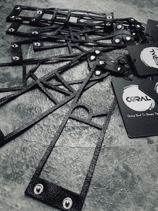 Elegant custom-cut tags with fine lamination, arranged on a sleek black surface with subtle blue neon highlights.