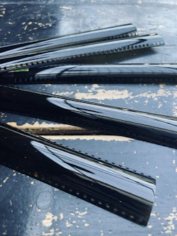 Photo of colorful 35mm film strips laid out on a dark surface with developing equipment.