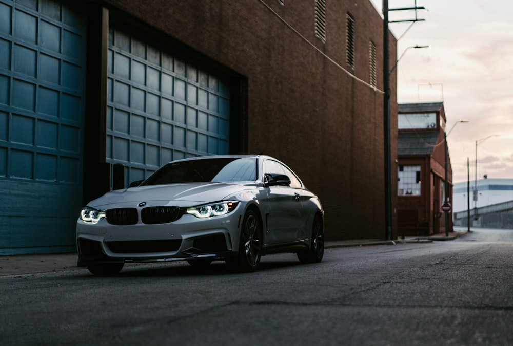 a silver car parked in front of a building