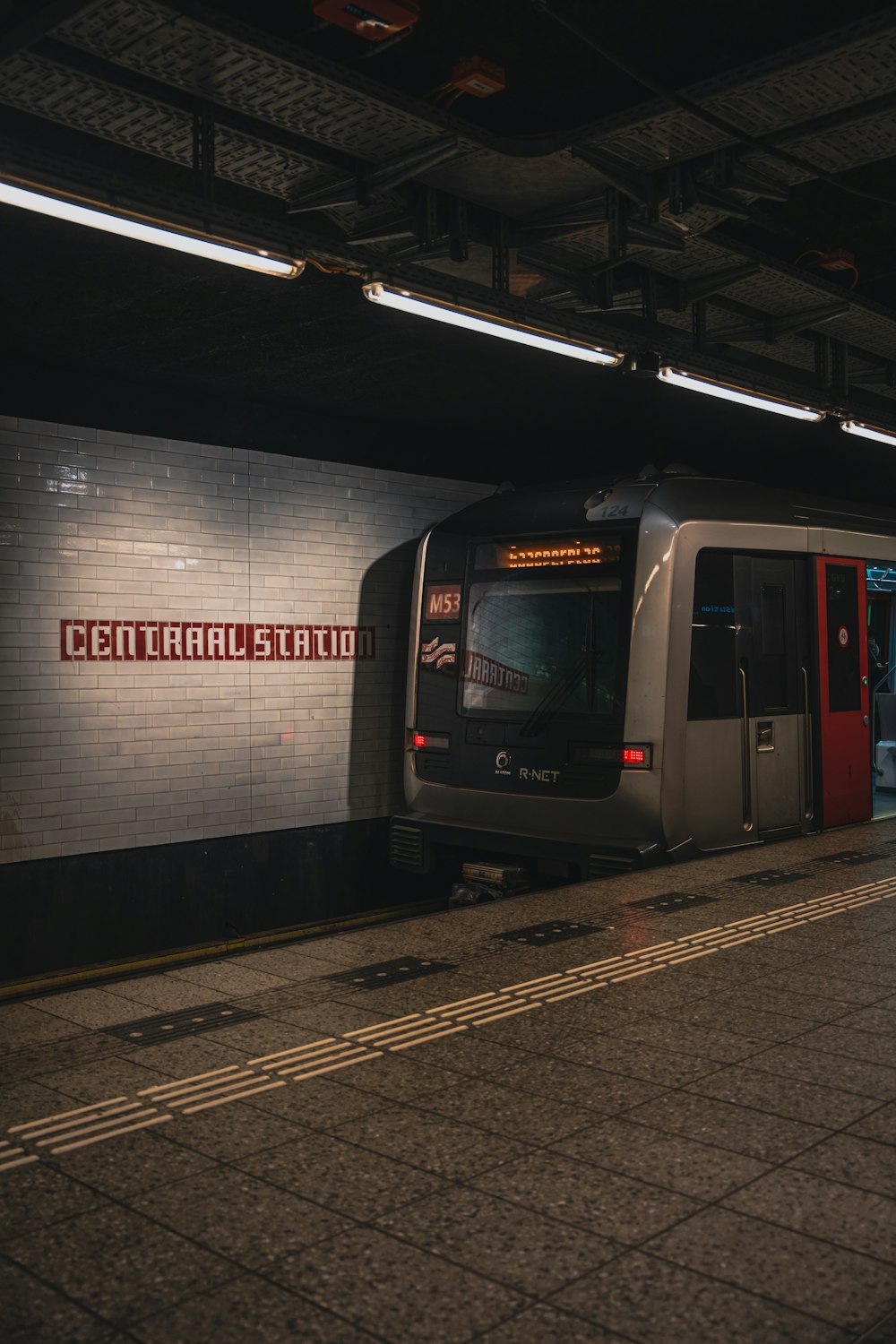 a subway train pulling into a train station