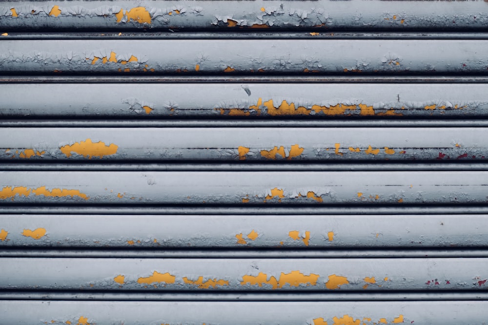 a close up of a metal structure with yellow paint