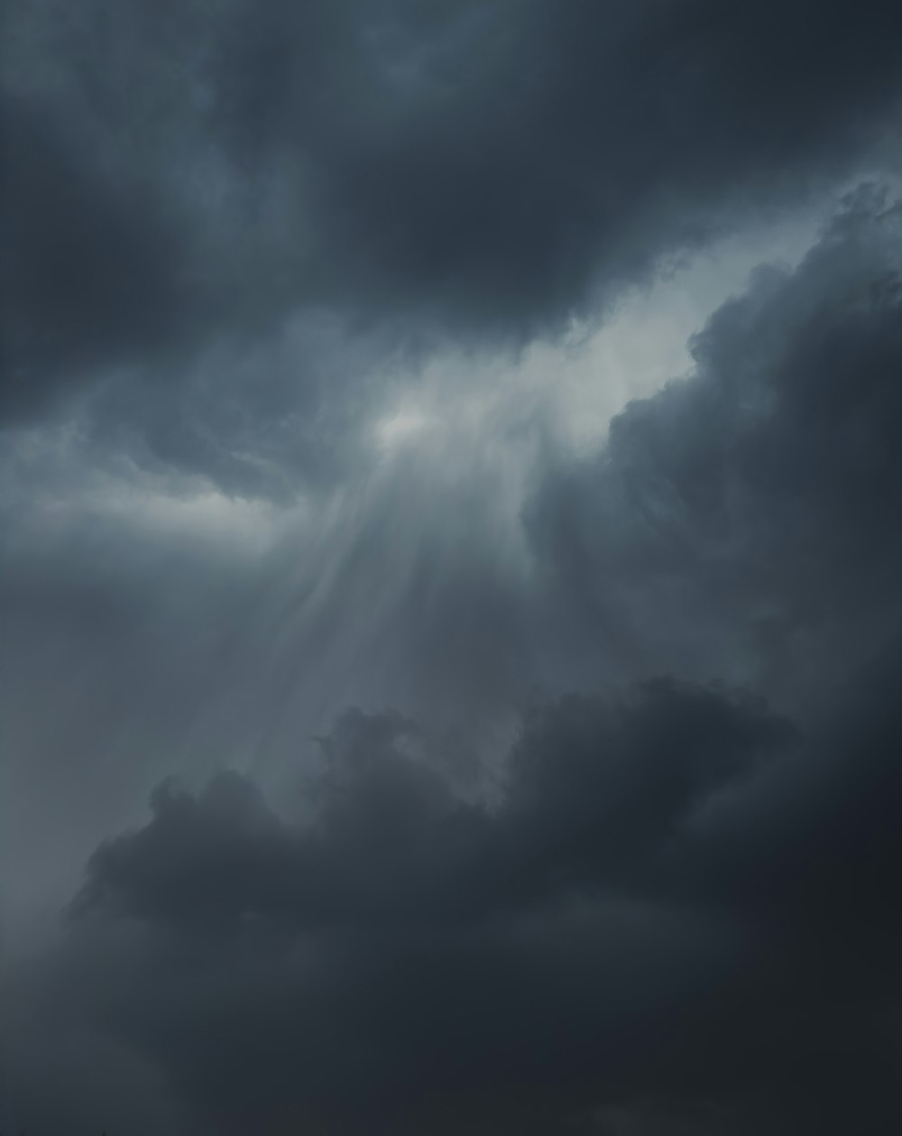 a plane flying through a dark cloudy sky