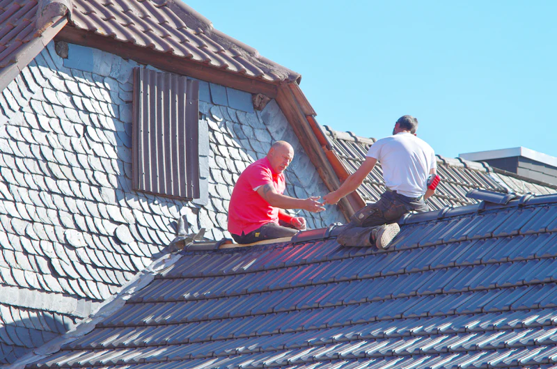Roofing crew on a residential roof tracing leaks and water entry points