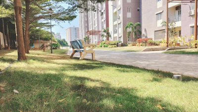 Green park area inside the apartment complex with benches.