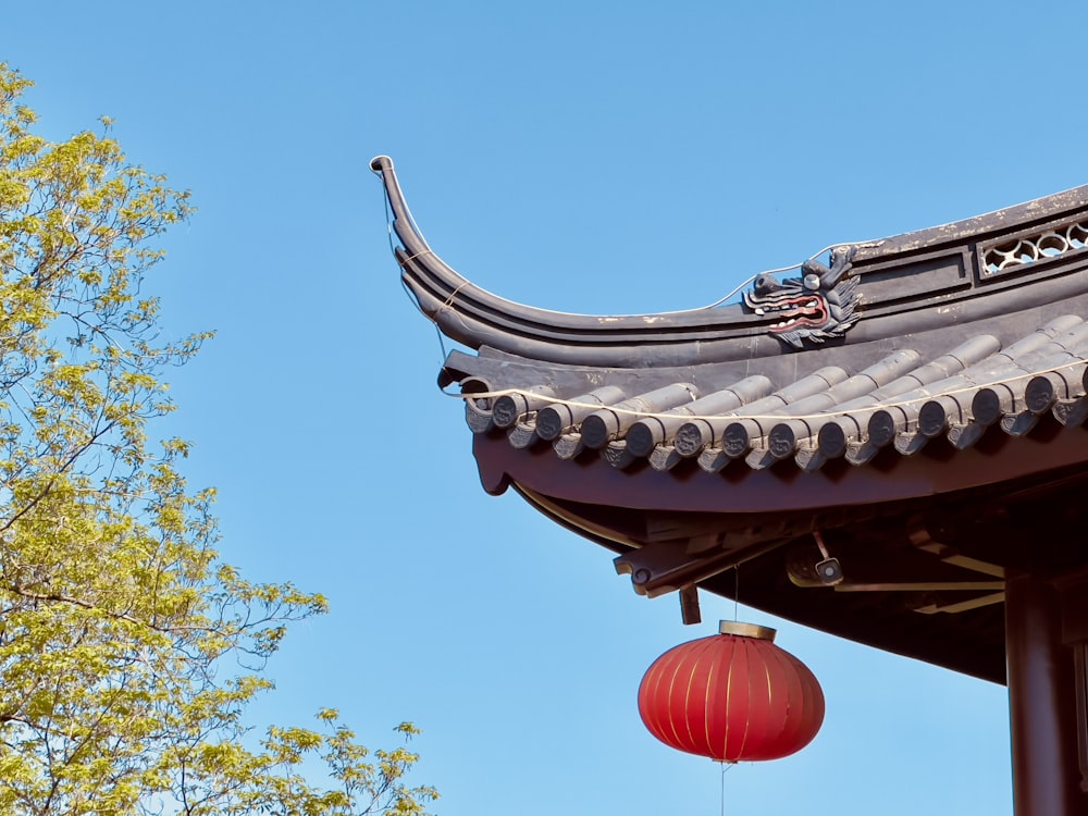 a red lantern hanging from the roof of a building