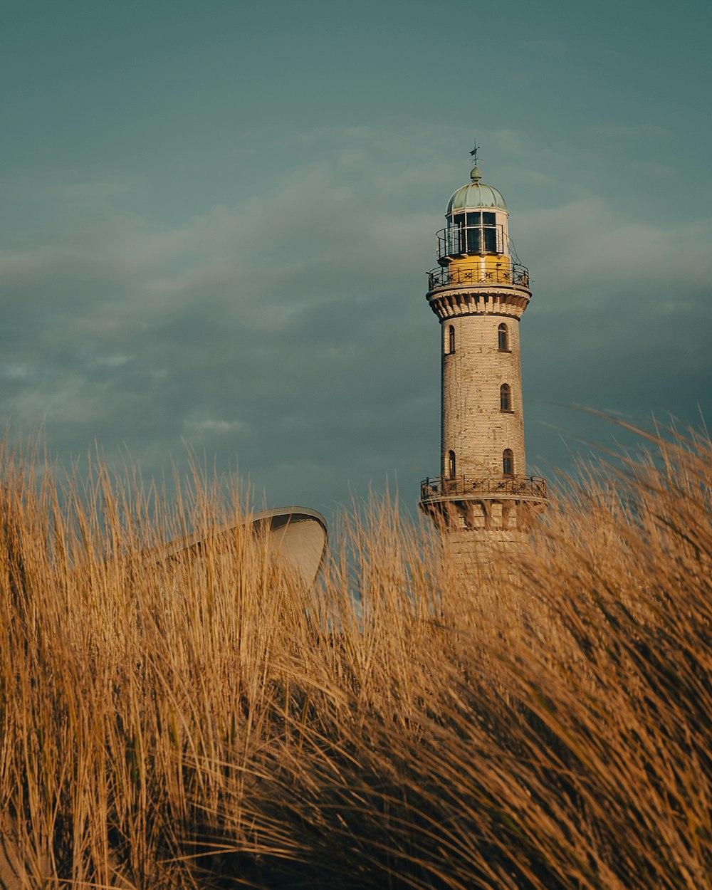 a light house in the middle of tall grass