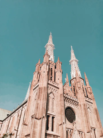 a very tall cathedral with a clock on it's side