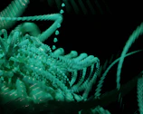 A sophisticated video background showing abstract artistic patterns in turquoise hues.