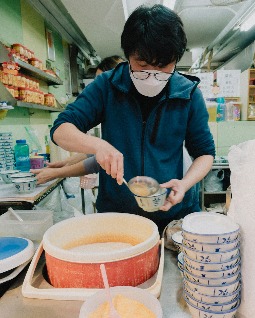a man in a mask is mixing something in a bowl