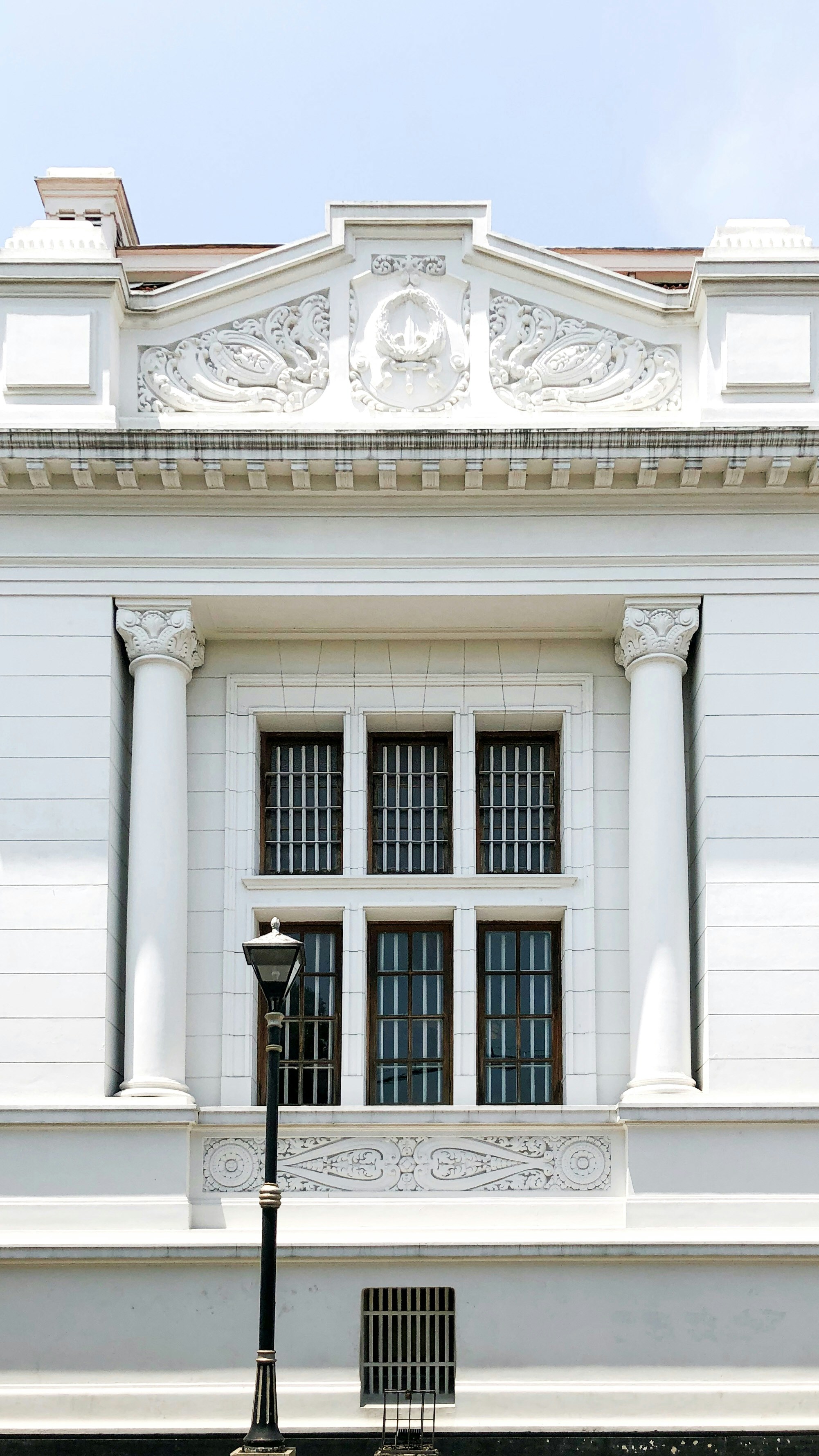 a white building with a street light in front of it