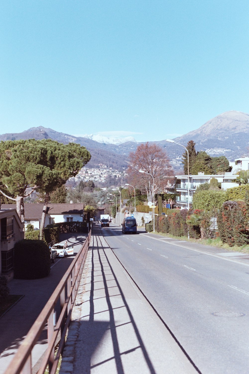 a view of a street with mountains in the background