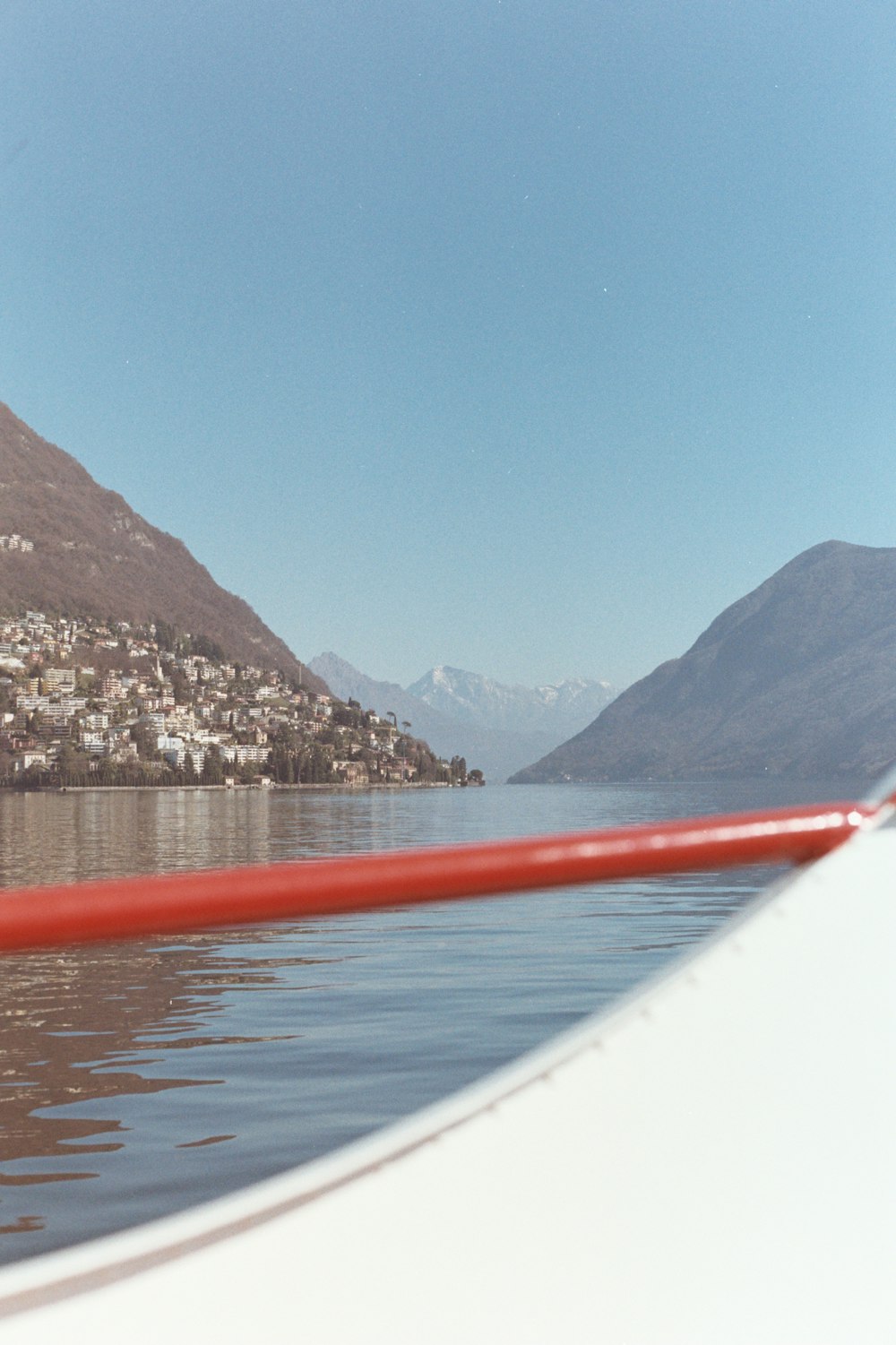 a view from a boat on a lake with mountains in the background