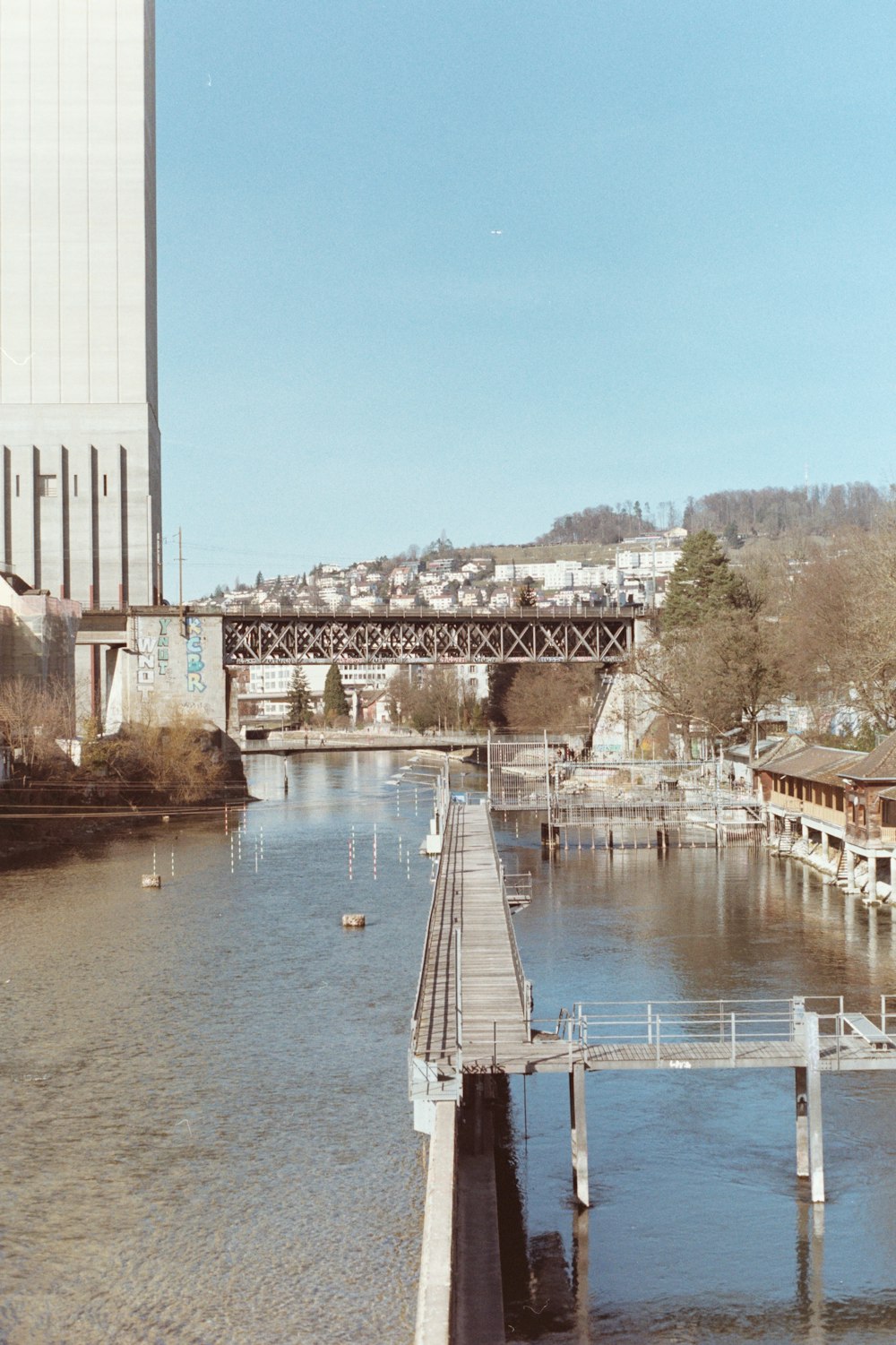 a bridge over a body of water next to a tall building
