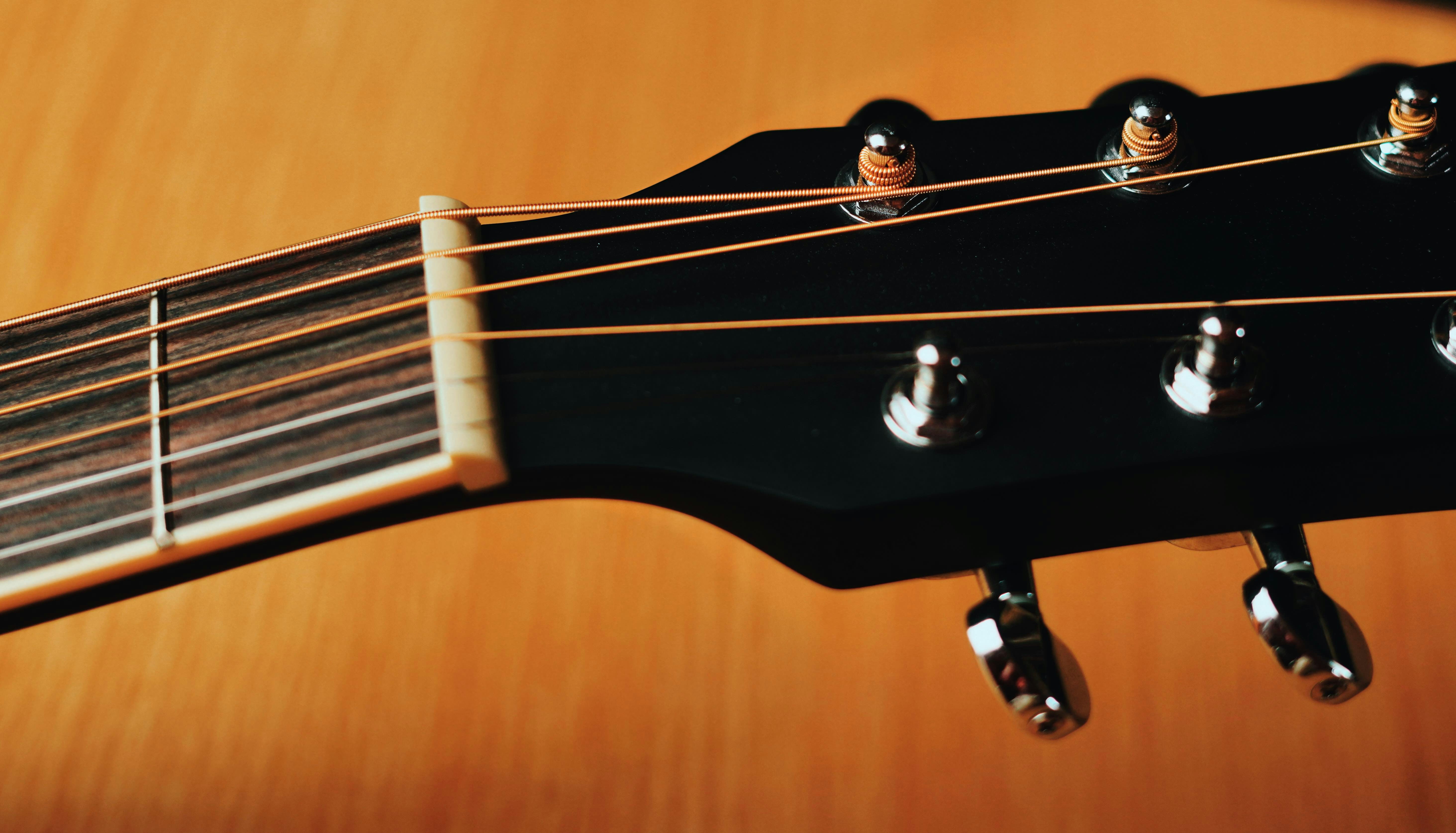 a close up of a guitar neck and strings