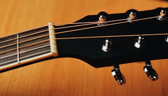 a close up of a guitar neck and strings