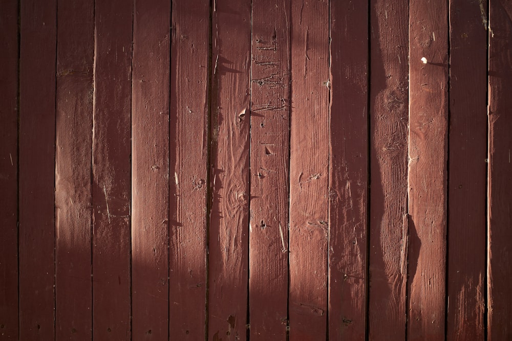 a close up of a red wooden fence