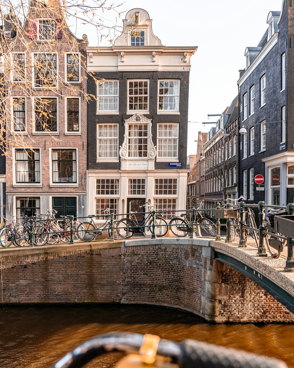 a bridge over a canal with bicycles on it