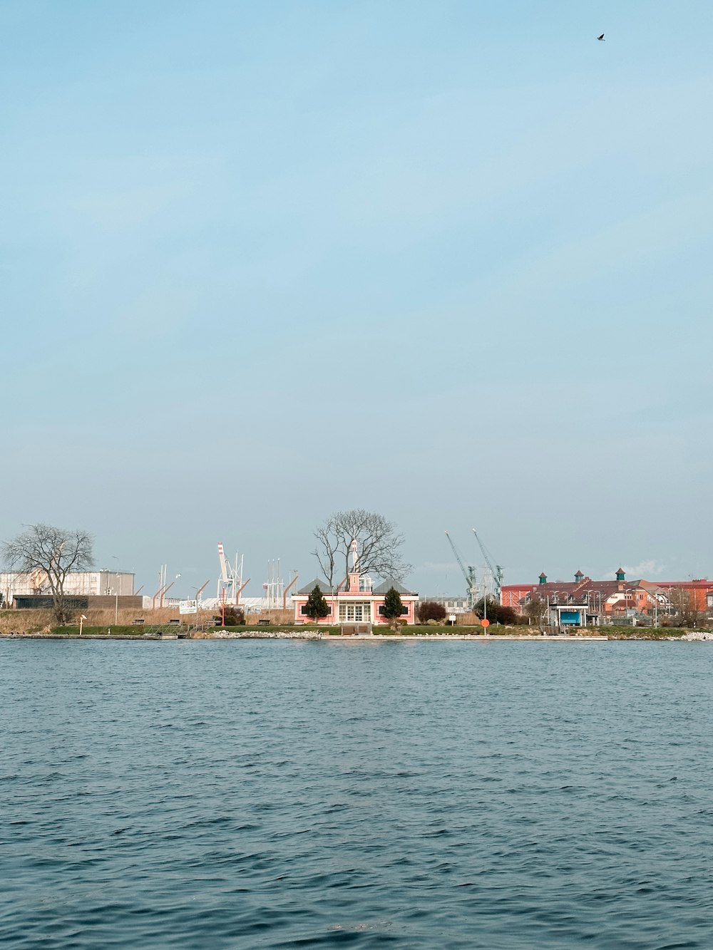 a large body of water with buildings in the background