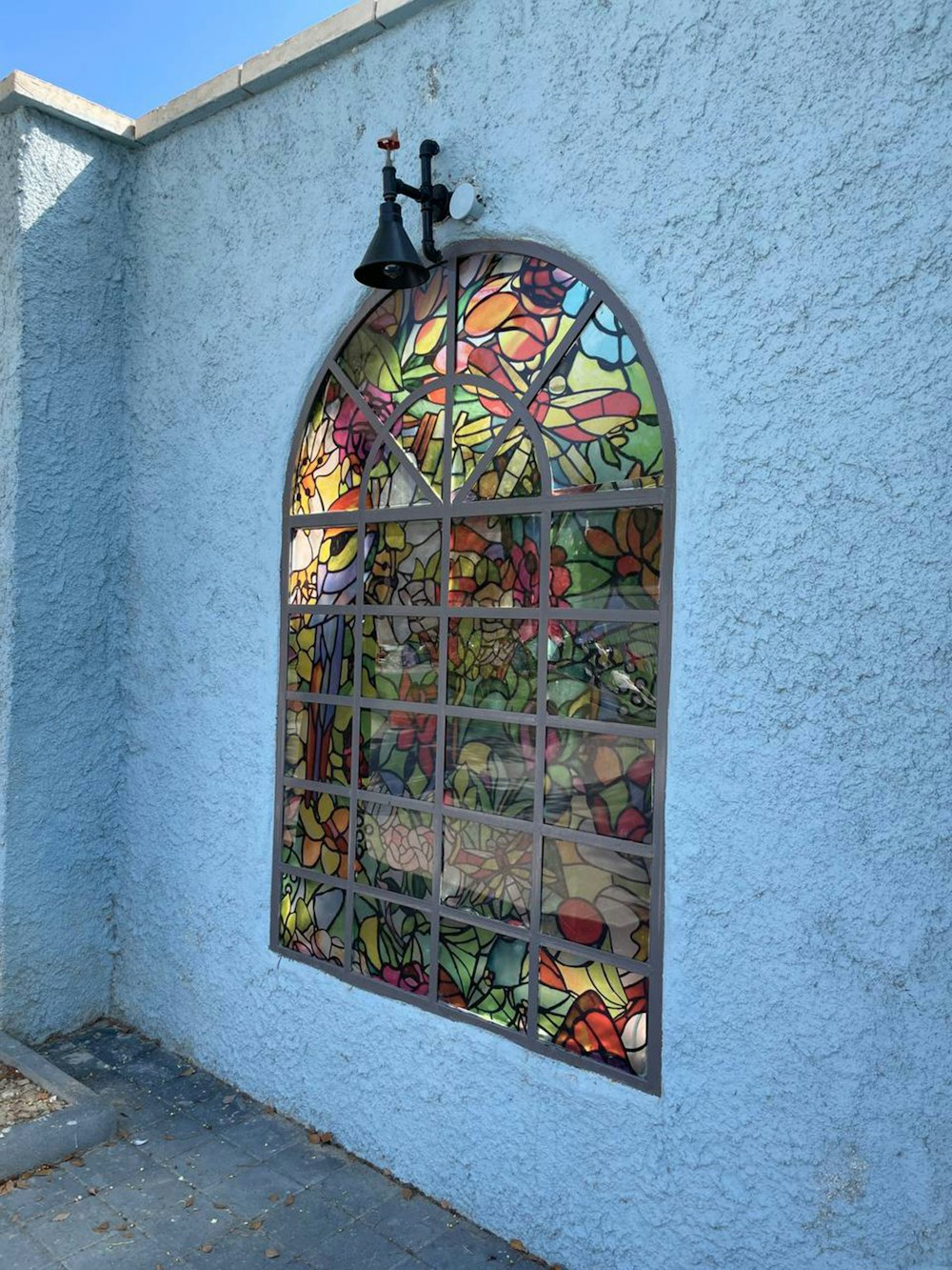 a stained glass window on the side of a building