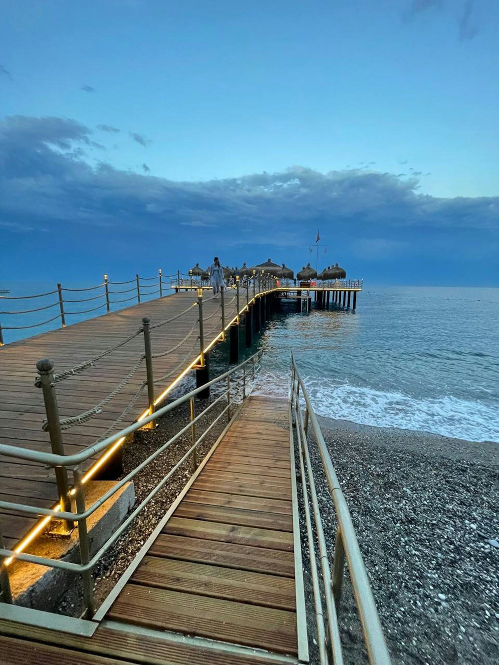 a wooden pier with stairs leading to the water