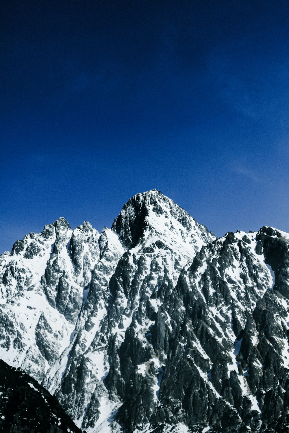 a snowboarder is going down a snowy mountain