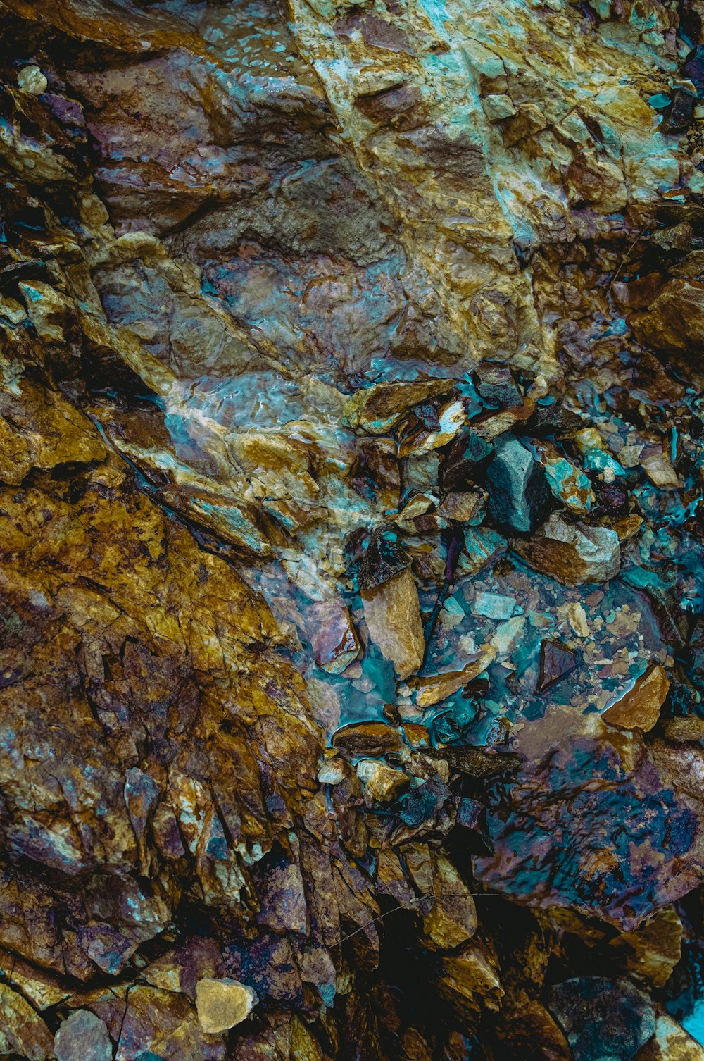 a close up of a rock with a blue and brown substance