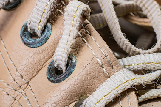 Close-up of worn running shoes on a cracked pavement at dawn.
